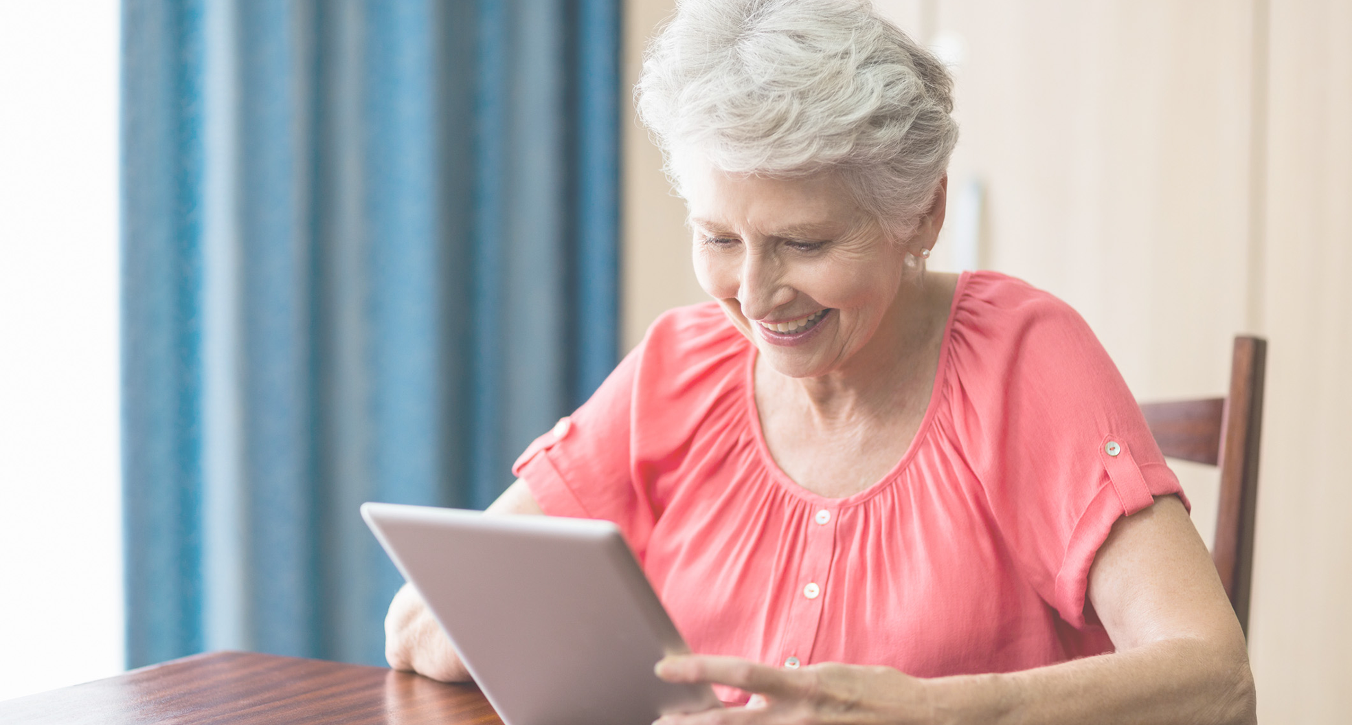 Older woman looking at tablet
